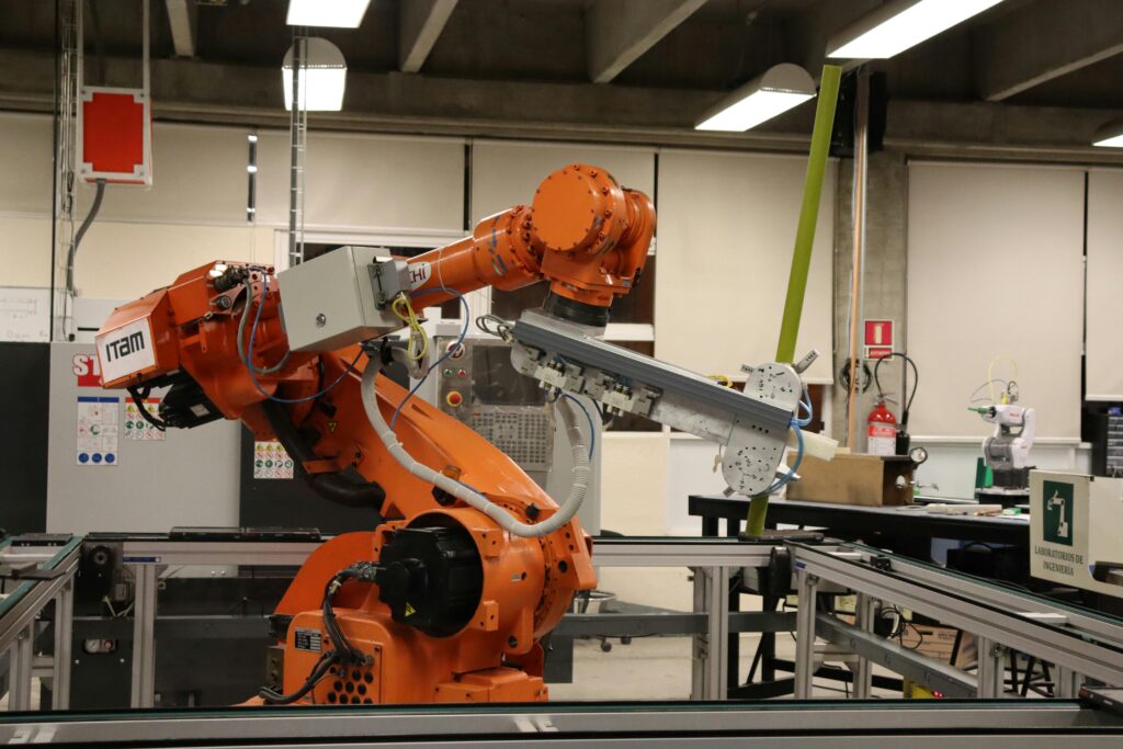 Industrial robotic arm performing automated manufacturing operation in factory