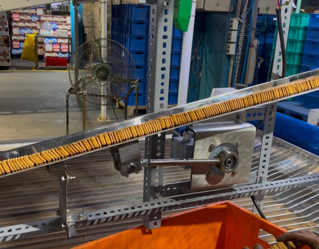 Close up view of vibrating biscuit feeder in factory